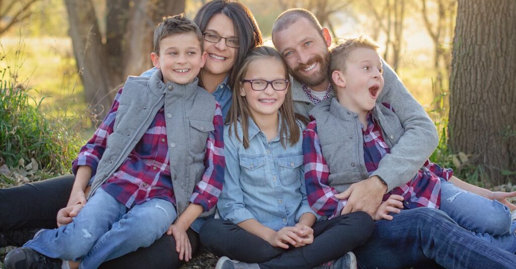 A joyful family portrait in matching outfits enjoying a sunny day outdoors.